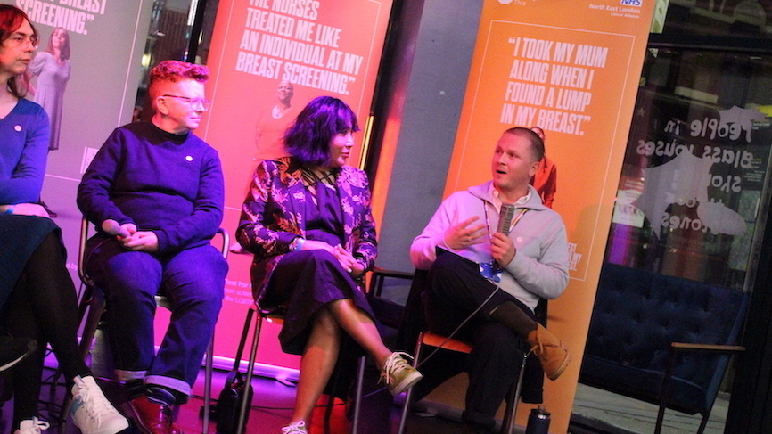 A panel of speakers sitting on a stage and answering questions from the audience.