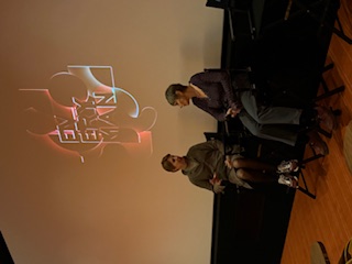 two women in front of a movie screen