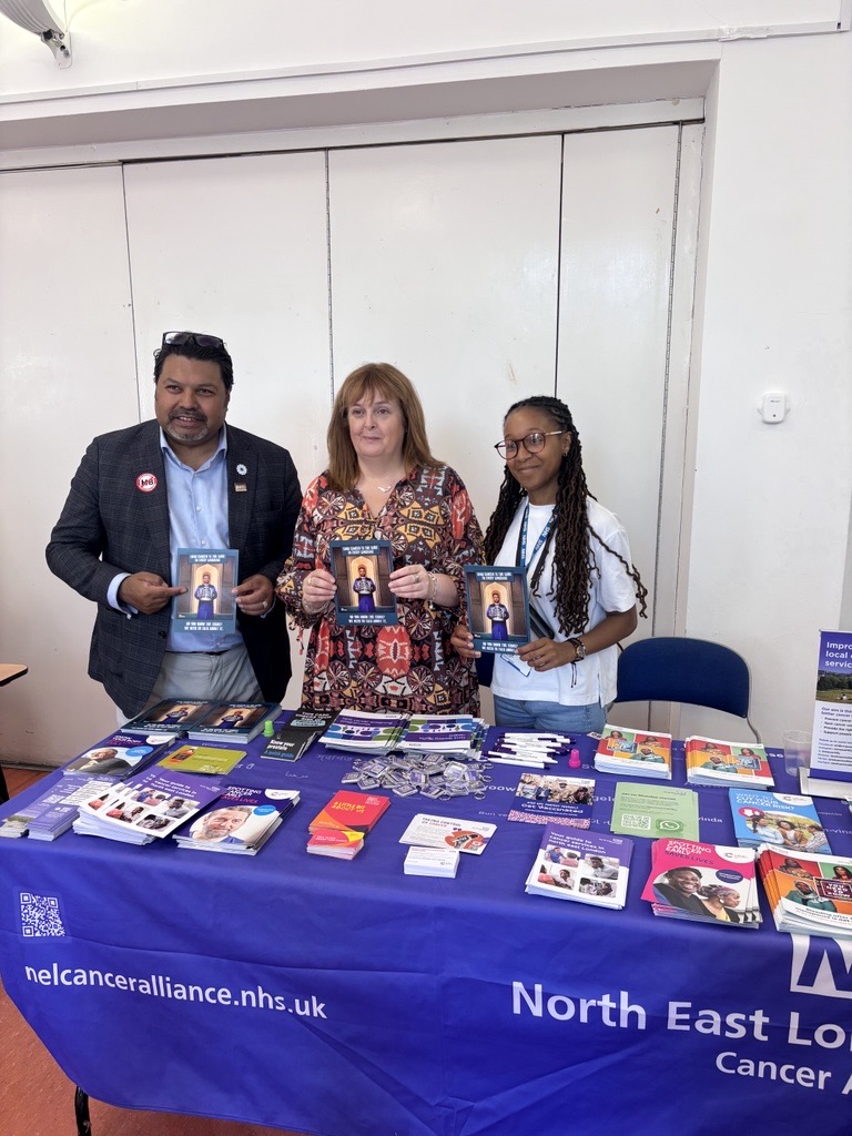 3 individuals holding campaign leaflet