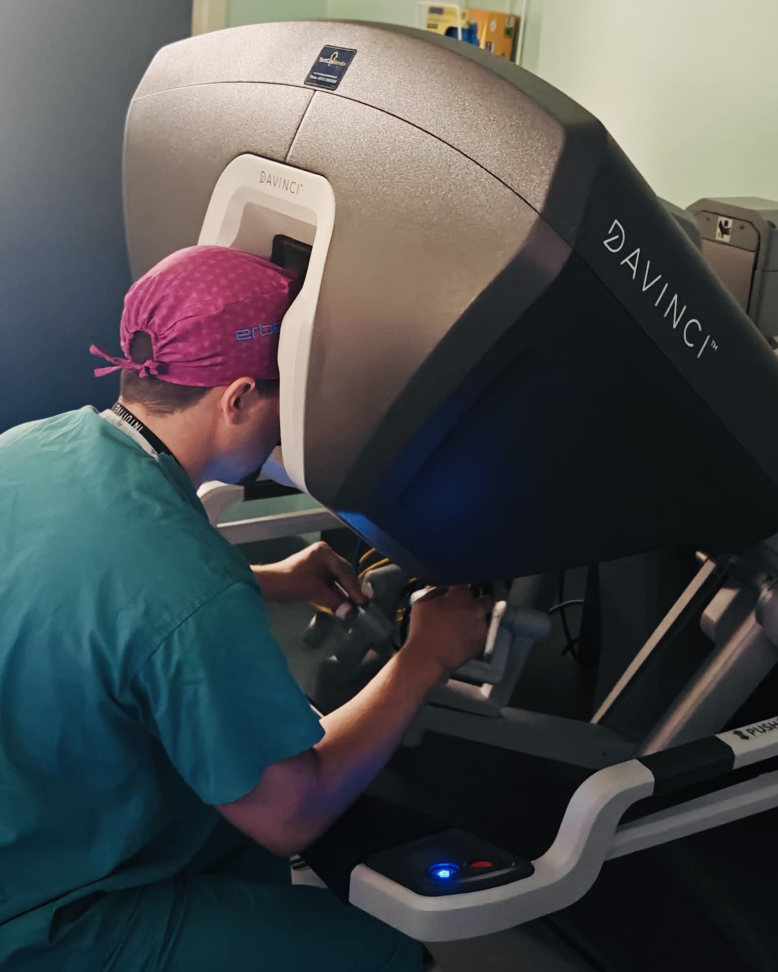 A clinician is performing robotic surgery.