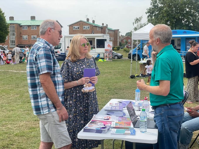 Councillors chat with a North East London Cancer Alliance representative at an outdoor community fun day