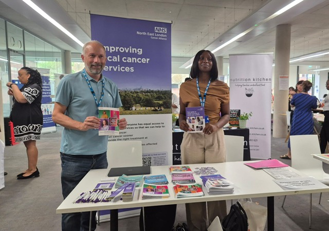 two people holding leaflets on cancer services