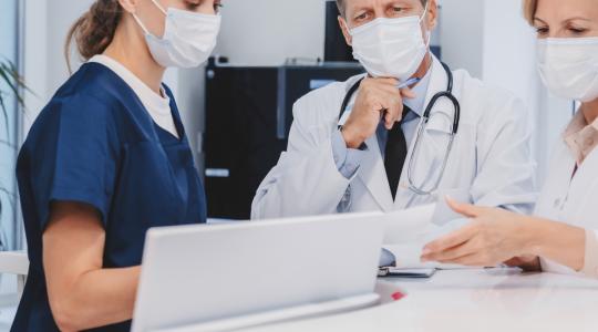 doctors talking at a desk