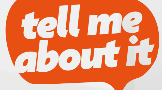 The words 'Tell Me About It' are written in white text in an orange speech bubble