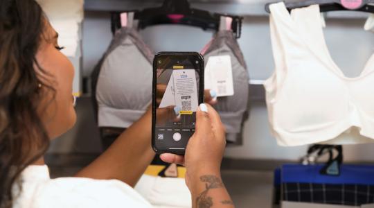 A women is scanning a QR code which is on a label on a bra