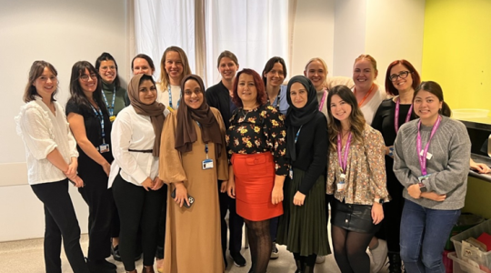 A team photo of a mix of people of different ages, gender and ethnic backgrounds