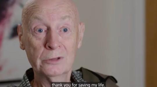The image is of an elderly bald man facing the camera. Text below him says 'Thank you for saving my life'