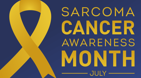 The image shows yellow text on a blue background which reads Sarcoma Cancer Awareness Month July. There is a yellow ribbon on the left.