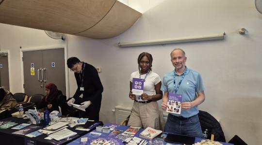 two people holding informative leaflet