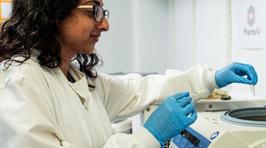 A clinician is undertaking tests in a lab.