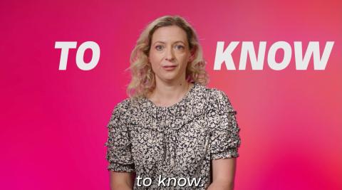 A women with blonde hair and a patterned dress is looking straight ahead against a pink background with the words To Know on it