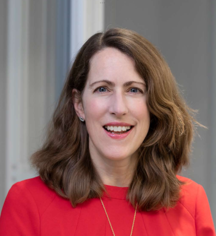 Portrait photo of a lady wearing a red top.