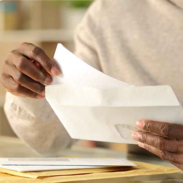 Person holding a sheet of paper