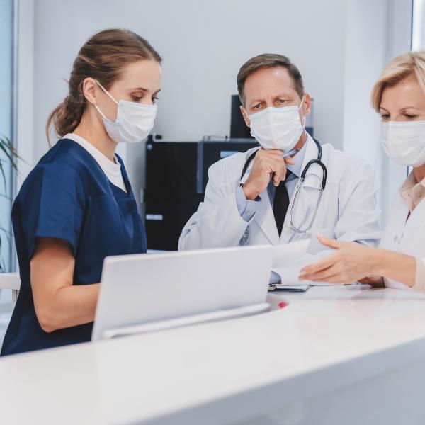 doctors talking at a desk